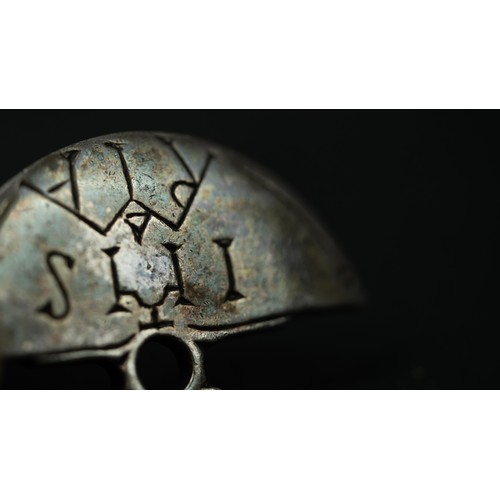 137 - A METAL PENDANT WITH ARMENIAN INSCRIPTION, Of semicircle form, engraved with Armenian inscription, w... 