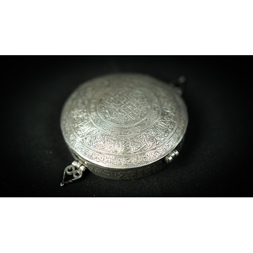 138 - A SAFAVID, ARABIC INSCRIPTION ENGRAVED SILVER BAZUBAND AMULET CASE 17TH CENTURY, IRAN, Of circular f... 