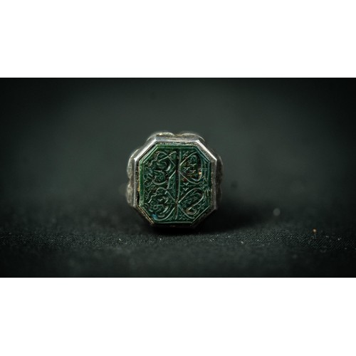 139 - A SILVER FRAMED ARABIC INSCRIPTION CARVED SPINACH GREEN JADE SEAL, Of octagon shape, the jade seal f... 