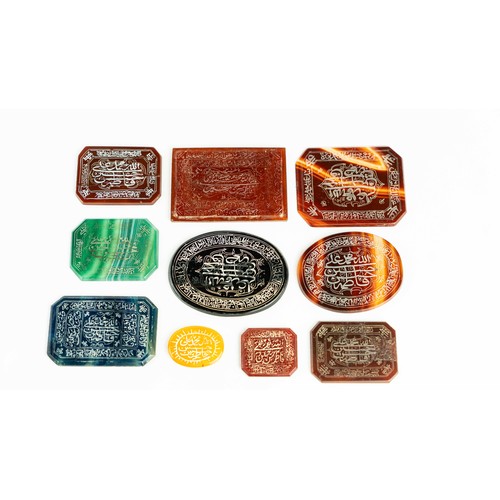 141 - A SET OF AGATE STONES WITH ARABIC INSCRIPTIONS, Of various forms, a group of hard stones, engraved w... 