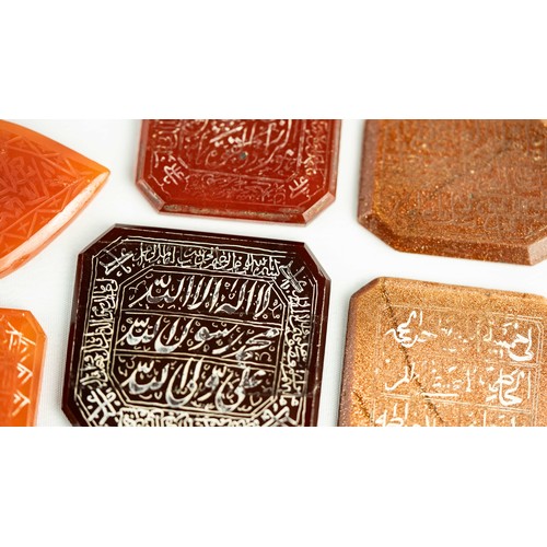 142 - A SET OF VARIOUS AGATE STONES WITH ARABIC INSCRIPTIONS, Of various colours, a group of hard stones c... 