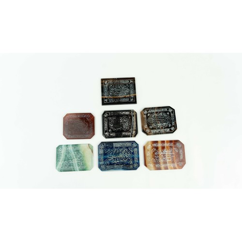 144 - A SET OF AGATE PLAQUES WITH ARABIC INSCRIPTIONS, Consisting of rectangular forms in various colours,... 