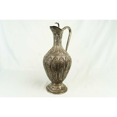 110 - AN ANGLO – INDIAN SILVER-PLATED COPPER JUG, KASHMIR, 19TH CENTURY, Of bulbous form, resting on a tap... 