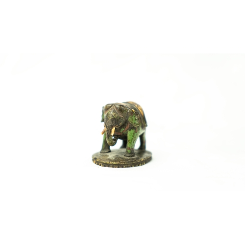 125 - A MUGHAL 17TH CENTURY TINY BONE SCULPTURE ORNAMENT, A model of an elephant, depicted standing with c... 