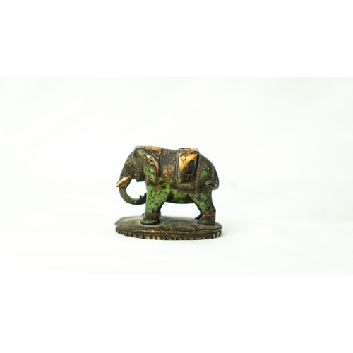 125 - A MUGHAL 17TH CENTURY TINY BONE SCULPTURE ORNAMENT, A model of an elephant, depicted standing with c... 