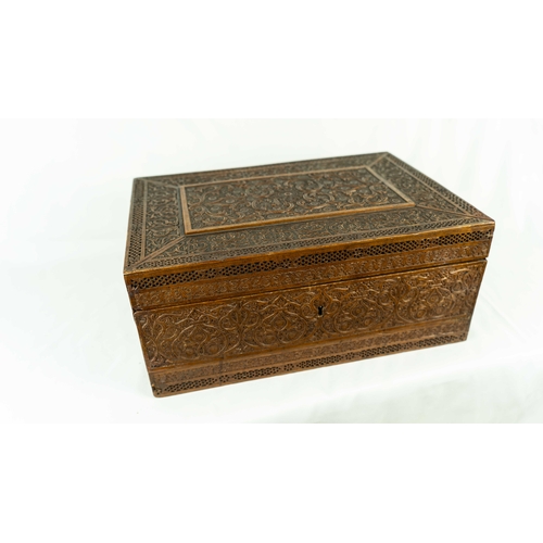 17 - A CARVED WOODEN BOX, Of typical rectangular form, resting on a flat wooden base, surmounted by a hin... 