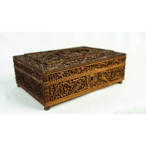 20 - A CARVED WOODEN BOX, EARLY 20TH CENTURY, INDIA, Of rectangular form, featuring intricate carvings de... 