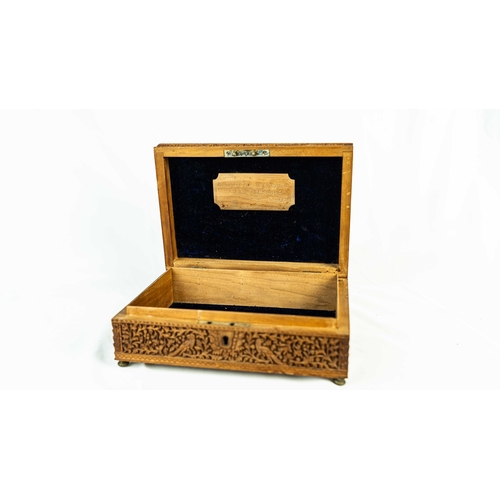 20 - A CARVED WOODEN BOX, EARLY 20TH CENTURY, INDIA, Of rectangular form, featuring intricate carvings de... 