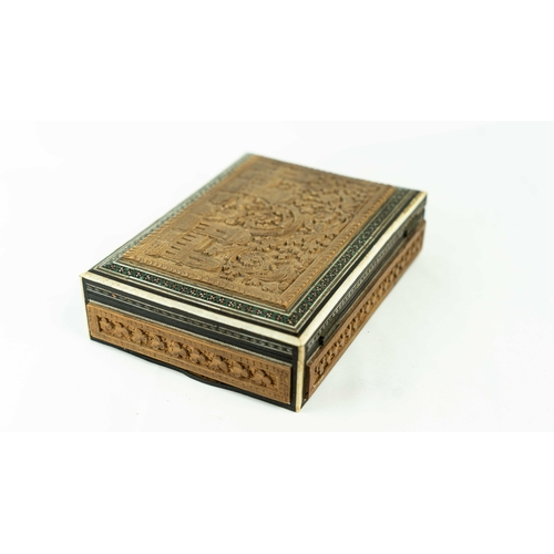 22 - AN ENGRAVED WOODEN BOX WITH A LANDSCAPE, Of rectangular form, a wooden box with a hinged lid, restin... 