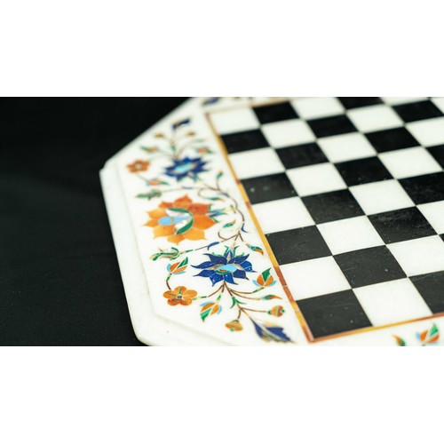 5 - AN OCTAGONAL INLAID MARBLE CHESSBOARD WITH FLOWERS, Of octagonal form, black and white checkered mar... 