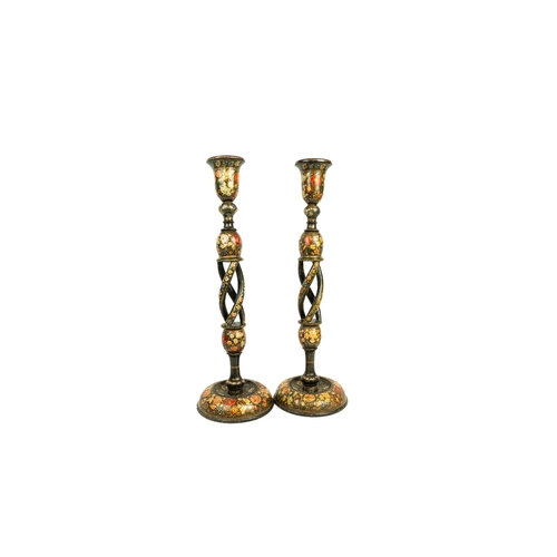 85 - A PAIR OF KASHMIRI LACQUERED CANDLESTICKS, 19TH CENTURY, Of resting on a circular base, rising to a ... 