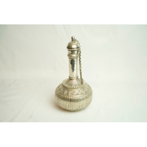 88 - AN OMANI WHITE METAL SURAHI, ROSE WATER FLASK, Of bulbous form, sitting on a circular base, its slen... 