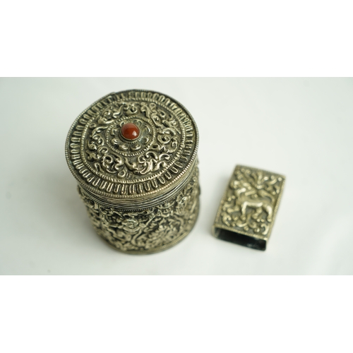 152 - A SILVER CIGARETTE BOX WITH A MATCHING MATCH BOX COVER, Of circular form, the body exquisitely embos... 