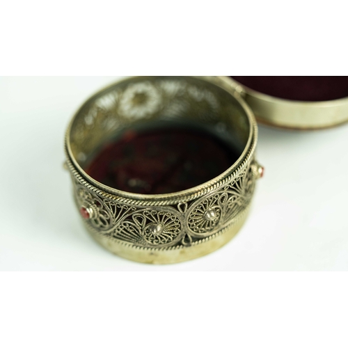 153 - A SILVER FILIGREE SNIFF BOX WITH ROSEWOOD LID, Of rounded form, the silver body adorned with a metic... 