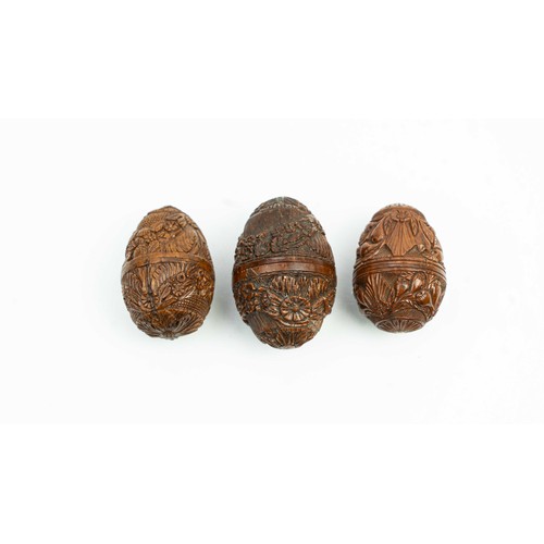 165 - THREE CARVED WOODEN EGGS, INDIA, In the shape of egg, each with  screw covers, intricately carved th... 