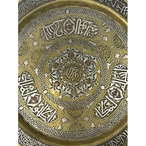 1 - A  BRASS ENGRAVED TRAY

Of circular shape, resting on a flat and plain base, rising to an everted ri... 