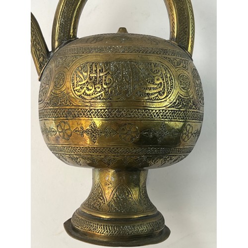 5 - A BRASS GLOBULAR EWER
19TH CENTURY
SYRIA

A Silver Inlaid Brass Ewer In Kendi Teapot Form
Of compres... 