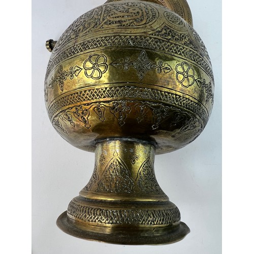 5 - A BRASS GLOBULAR EWER
19TH CENTURY
SYRIA

A Silver Inlaid Brass Ewer In Kendi Teapot Form
Of compres... 