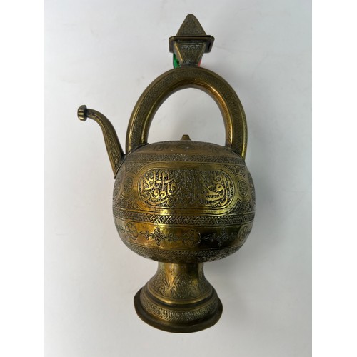 5 - A BRASS GLOBULAR EWER
19TH CENTURY
SYRIA

A Silver Inlaid Brass Ewer In Kendi Teapot Form
Of compres... 