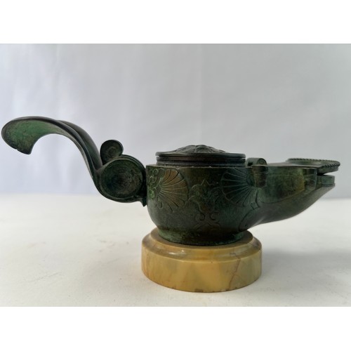 6 - A BRONZE 
INCENSE BURNER WITH MARBLE BASE

Featuring a circular main body, the lid with a mythologic... 