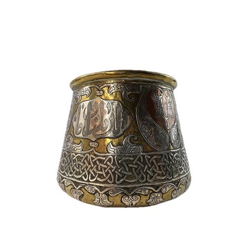 9 - A MAMLUK SILVER INLAID SMALL BRASS BOWL

Of rounded shape with a flat base and gently rounded edges,... 