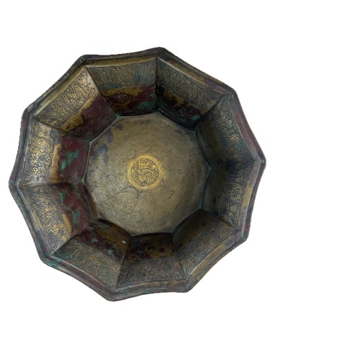 13 - KHURASAN  DECAGONAL BRASS BASIN

Of scallop form, resting on a flat base, a central medallion with. ... 