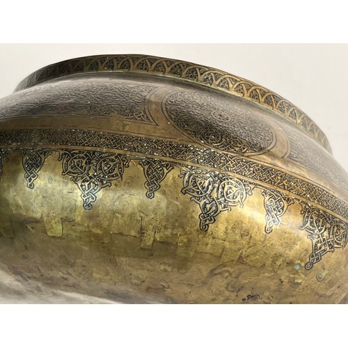 14 - A BRASS BOWL

Of compressed form, resting on a concave base, tapering to a narrow rim, the exterior ... 