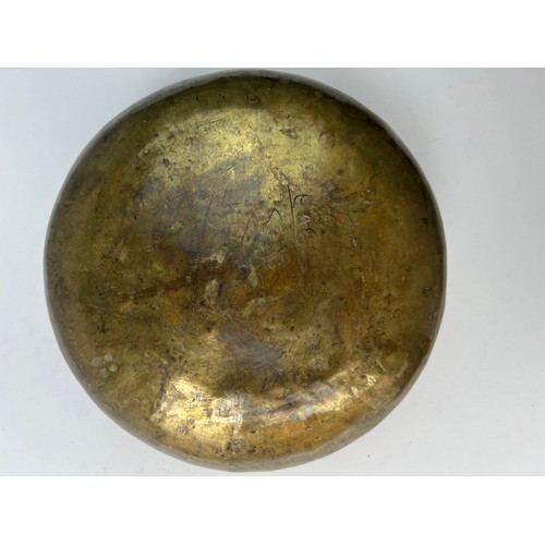 14 - A BRASS BOWL

Of compressed form, resting on a concave base, tapering to a narrow rim, the exterior ... 