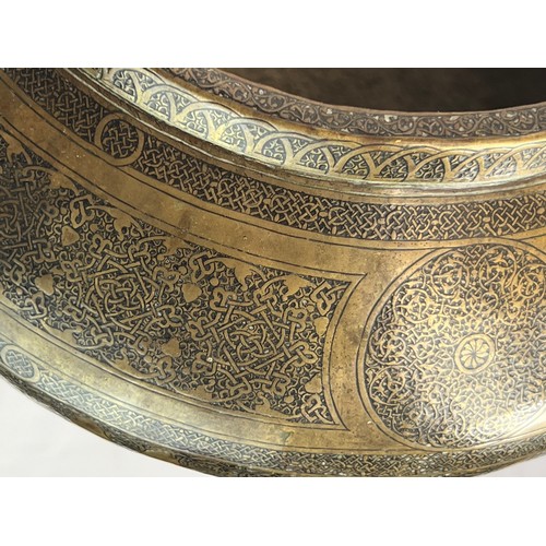 14 - A BRASS BOWL

Of compressed form, resting on a concave base, tapering to a narrow rim, the exterior ... 