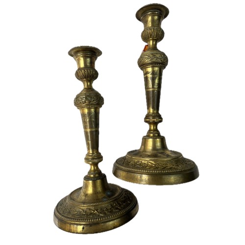 15 - A PAIR OF BRASS CANDLE STICK

A pair of brass candle sticks resting on splayed circular foot, emboss... 