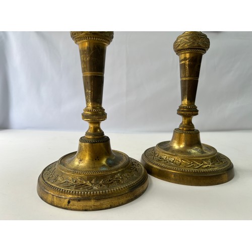 15 - A PAIR OF BRASS CANDLE STICK

A pair of brass candle sticks resting on splayed circular foot, emboss... 