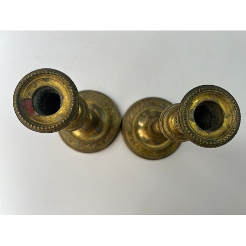 15 - A PAIR OF BRASS CANDLE STICK

A pair of brass candle sticks resting on splayed circular foot, emboss... 