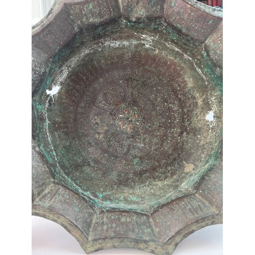 25 - A 
KHORASSAN  BRASS BASIN,

Of deep-form with everted scalloped rim, inside decorated with a broad b... 