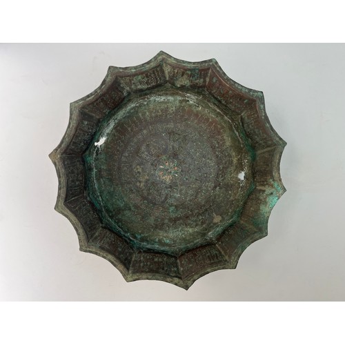 25 - A 
KHORASSAN  BRASS BASIN,

Of deep-form with everted scalloped rim, inside decorated with a broad b... 