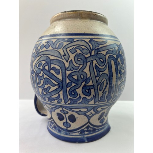 42 - A BLUE WHITE POTTERY JUG,

Of globular shape, resting on a short circular foot, with a circular neck... 