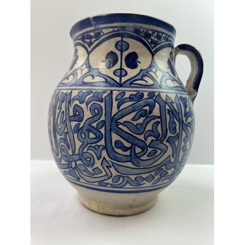 42 - A BLUE WHITE POTTERY JUG,

Of globular shape, resting on a short circular foot, with a circular neck... 