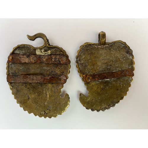 46 - A BRASS BELT BUCKLE
Containing
 two detachable plaques, each of drop-like shape with an upward-turne... 