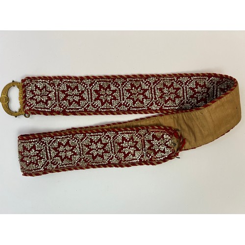 50 - A CRAFTMANSHIP BEADWORK BELT WITH BUCKLE

Mounted on a cream textile, adorned with successive eight ... 