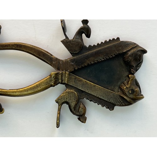 54 - A METAL SUGAR AND BETEL NUT CRACKER
A brass sugar and nut cracker, featuring two scissor-like handle... 