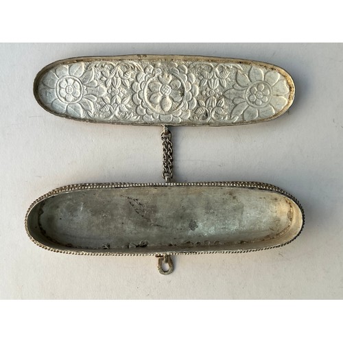 61 - AN ENGRAVED METAL PEN CASE
Of typical form with rounded ends and a lid, decorated with embossed flow... 