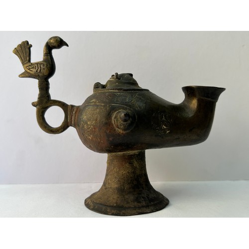 67 - A BRONZE ORNAMENT AS AN INCENCE BURNER OR OIL LAMP
Of rounded form, resting on a splayed circular fo... 