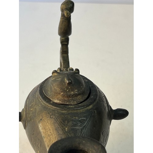 67 - A BRONZE ORNAMENT AS AN INCENCE BURNER OR OIL LAMP
Of rounded form, resting on a splayed circular fo... 