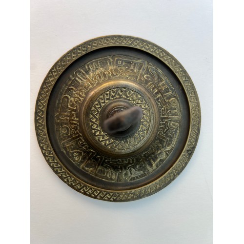 74 - A BRASS DOOR LOCK PIECE
Of circular form, a brass door ornament featuring an intricate Arabic callig... 