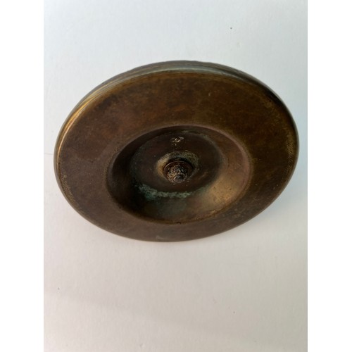 74 - A BRASS DOOR LOCK PIECE
Of circular form, a brass door ornament featuring an intricate Arabic callig... 