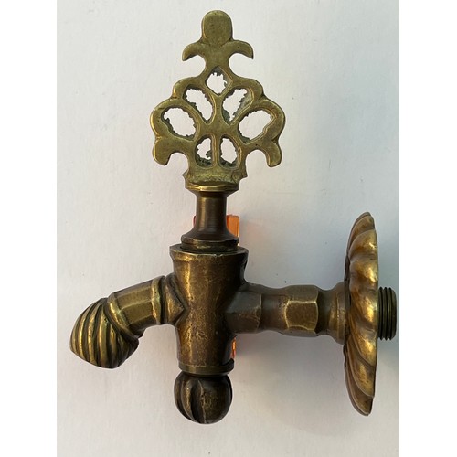 76 - AN OTTOMAN BRASS FAUCET,
A brass faucet with a decorative, ornate design, featuring an openwork hand... 