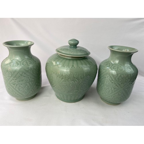 87 - A SET OF CHINESE CELADON PORCELAIN
A pair of Chinese Celadon vases and a jar with lid, bearing four ... 