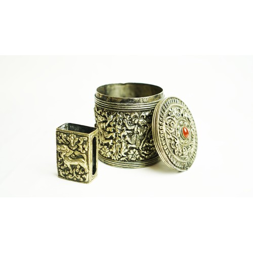 164 - A SILVER CIGARETTE BOX WITH A MATCHING MATCH BOX COVER
Of circular form, the body exquisitely emboss... 