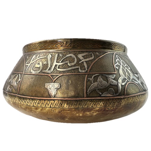 8 - A MAMLUK STYLE SILVER INLAID BRASS BOWL

Of compressed form, decorated with Arabic inscriptions and ... 