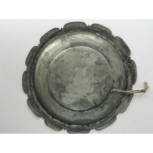 20 - A MAMLUK 
STYLE COPPER DISH,

Of shallow circular form, resting on short foot with cusped and flat r... 