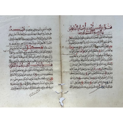 61 - A BIFOLIO FROM A RELIGIOUS BOOK, NORTH AFRICA, 19TH CENTURY 

Arabic manuscript on paper, 14ll. of b... 